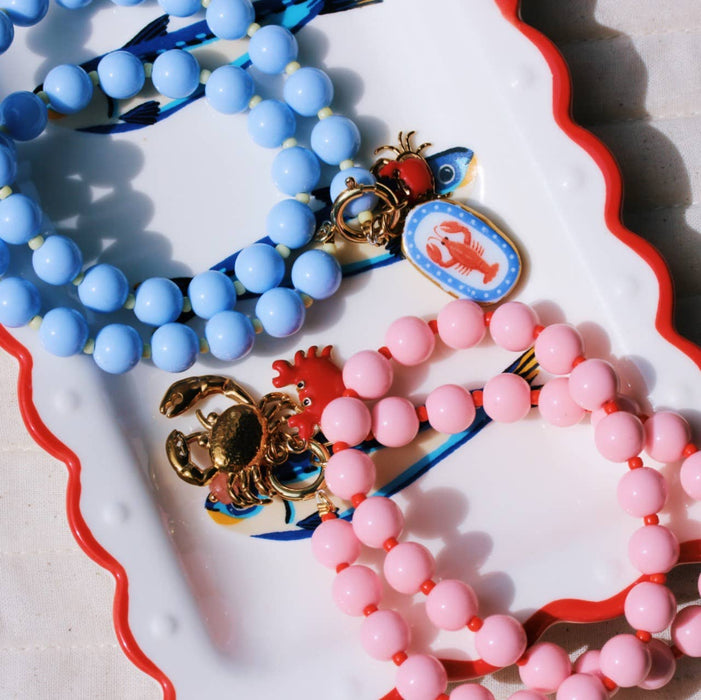 Kralenketting met Miyuki-kraaltjes en bedeltjes - fuchsia/oranje